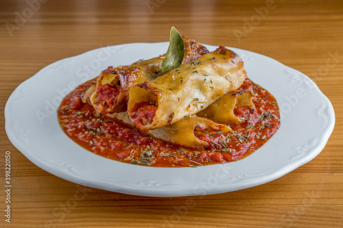 Homemade cannelloni with spices and tomato sauce