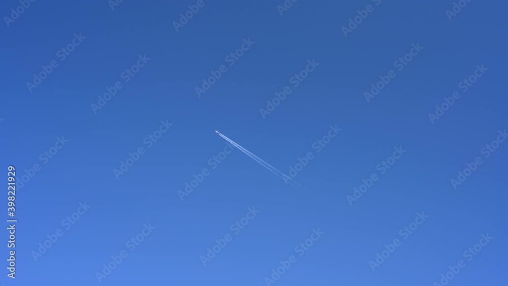 Passenger airplane at cruising altitude against blue sky. Passenger airplane at cruising altitude against blue sky.