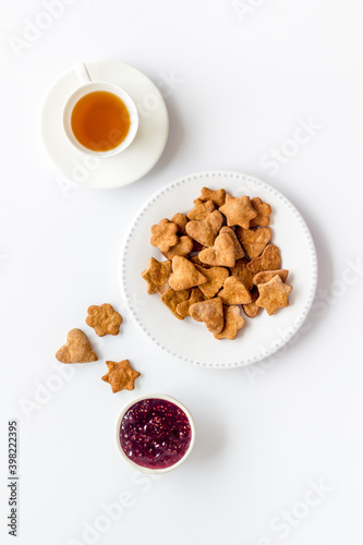 Chocolate cookies flat lay with berry jam and tea