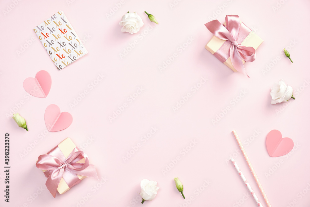 Cute Valentines day composition. Flat lay gift boxes with ribbon bow, greeting card, paper hearts, roses flowers on pastel pink background.