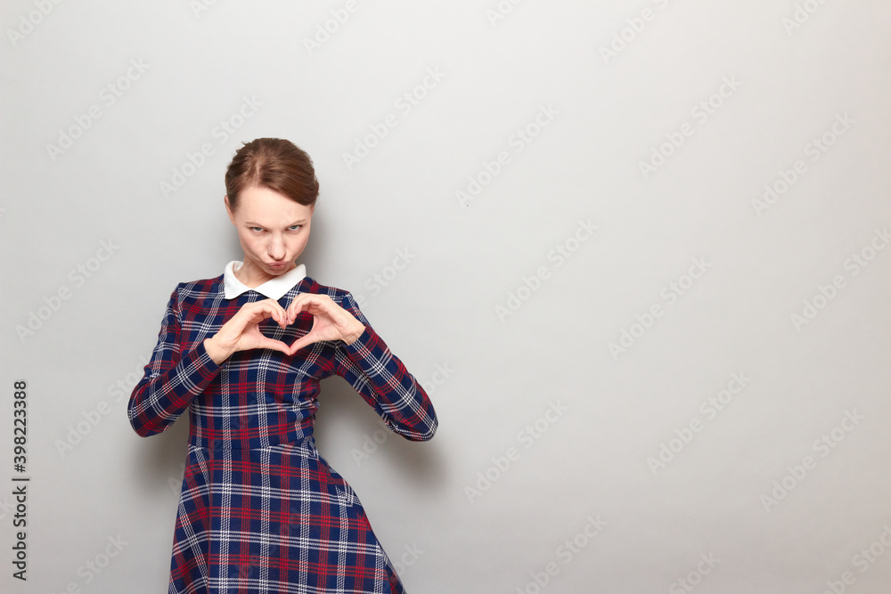 Funny flirty girl is making heart gesture and posing for sexy photo Funny flirty girl is making heart gesture and posing for sexy photo