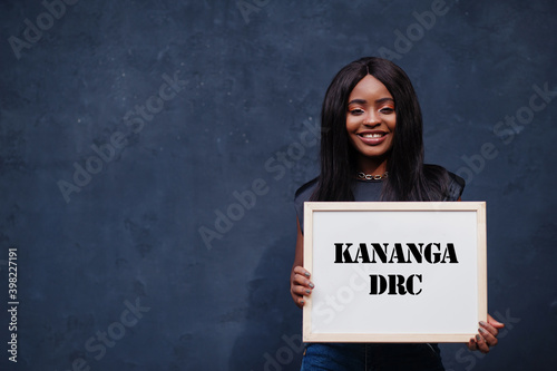 African woman hold white board with Kananga DRC inscription. Most populous city in Africa concept. photo