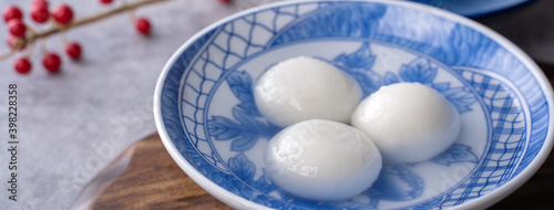 Close up of tangyuan in a bowl on gray table, food for Winter Solstice.