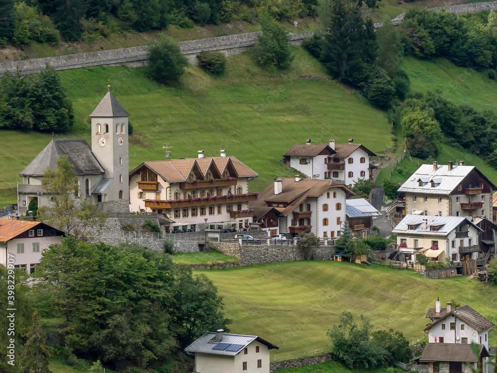 A glimpse of Gomagoi, Stelvio, South Tyrol, Italy, with the parish church and other buildings surrounded by greenery