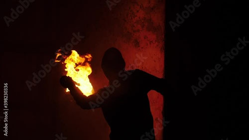 Close footage of anonymous protester throw burning Molotov's cocktail. Sign of protest and terroristic destruction 