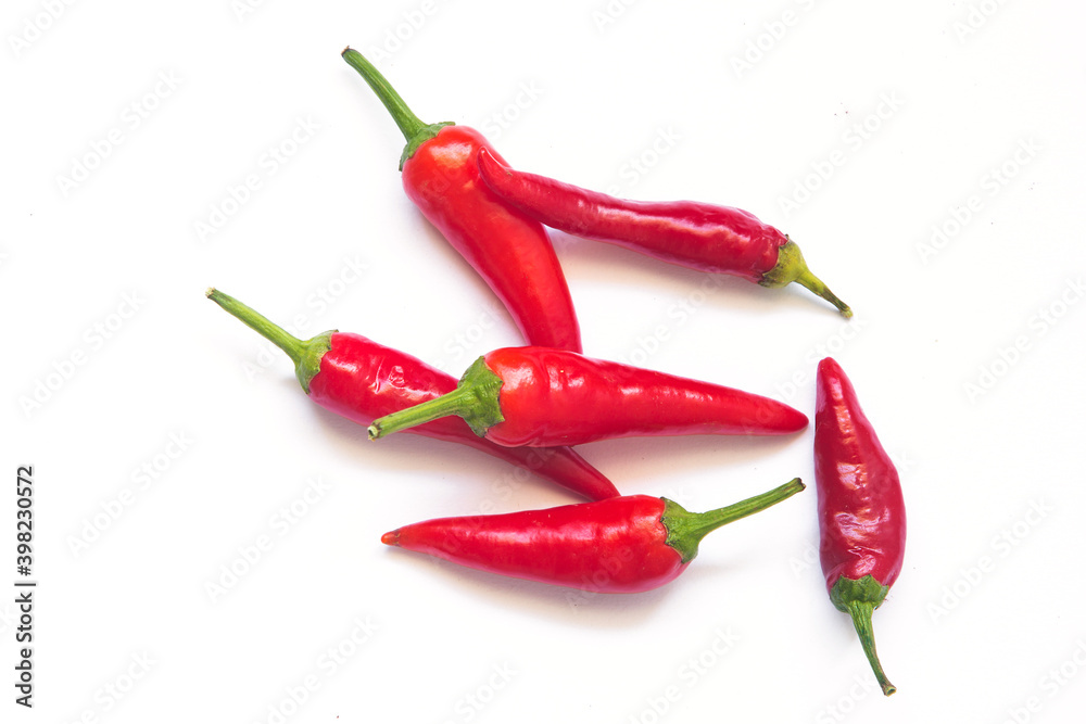green and red hot chili peppers on a white background. 