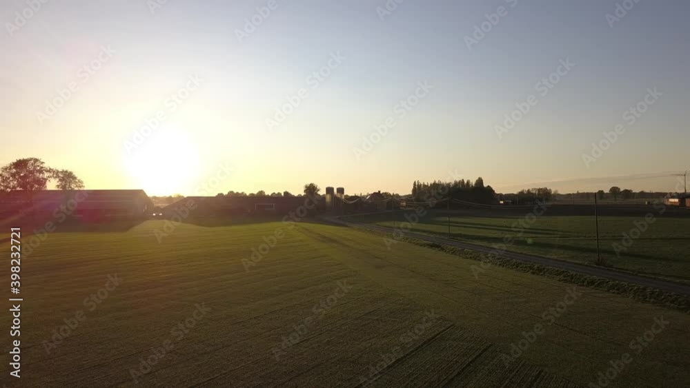 Aerial Cinematic clip,Drone flying over a farm field during sunset. Drone flies over green agriculture wheat field. Beautiful summer landscape of a wheat field. Top view to the farm wheatfield. Aerial Cinematic clip,Drone flying over a farm field during sunset. Drone flies over green agriculture wheat field. Beautiful summer landscape of a wheat field. Top view to the farm wheatfield.