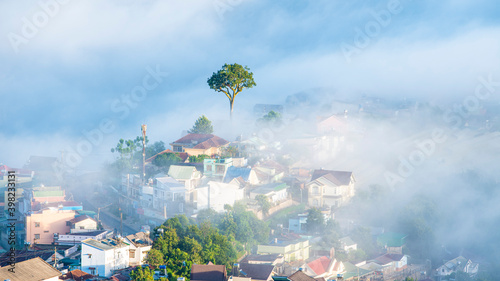 Many houses in in the mist in the morning. Early morning fog and mist burns off over large houses nestled in green rolling hills