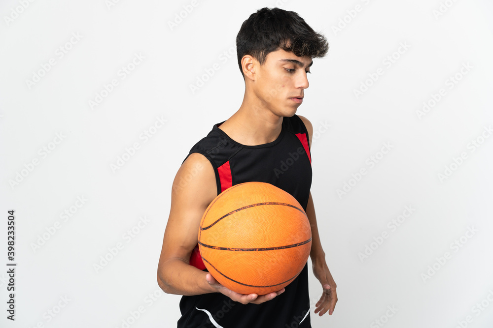 Young man over isolated white background playing basketball