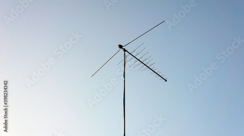 Old antenna against the blue sky on a sunny day © Konstantin
