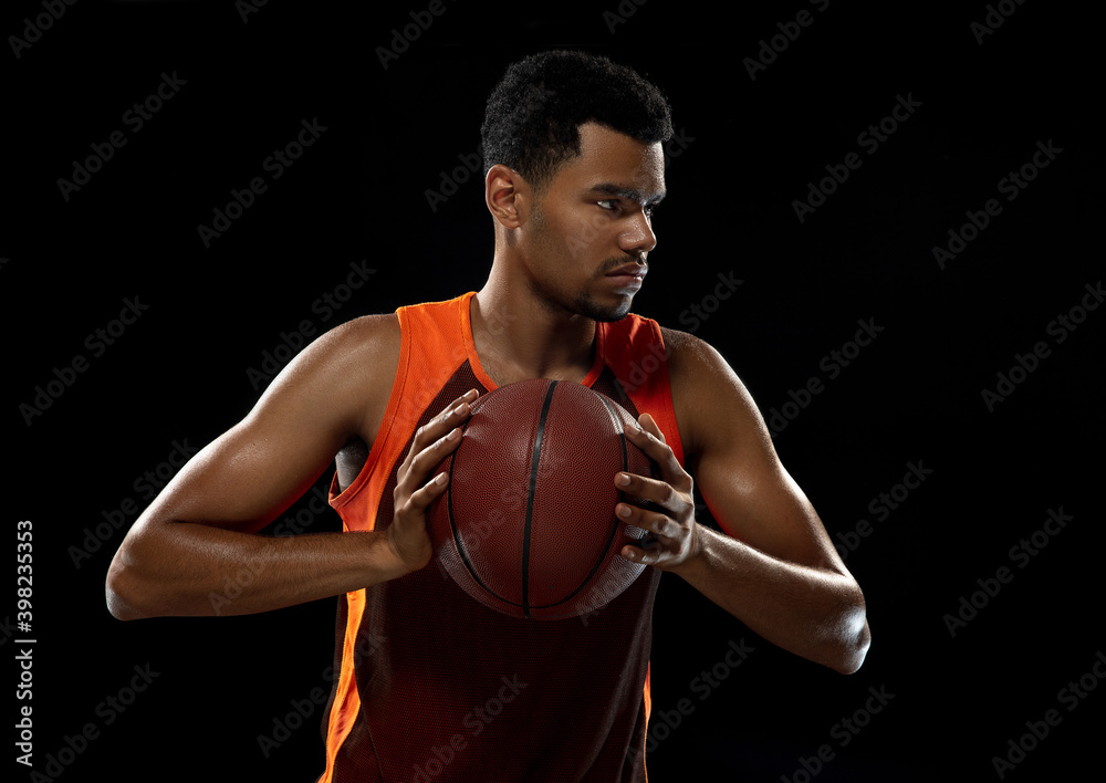 Ready. Young purposeful african-amrican basketball player training, practicing in action, motion isolated on black background. Concept of sport, movement, energy and dynamic, healthy lifestyle. Ready. Young purposeful african-amrican basketball player training, practicing in action, motion isolated on black background. Concept of sport, movement, energy and dynamic, healthy lifestyle.