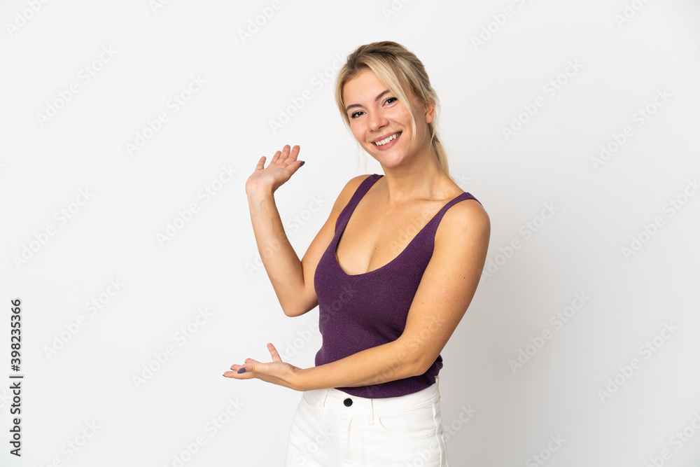 Young Russian woman isolated on white background extending hands to the side for inviting to come Young Russian woman isolated on white background extending hands to the side for inviting to come