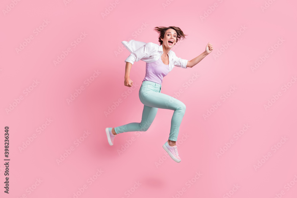 Full length portrait of attractive running fast lady open mouth excited isolated on pink color background