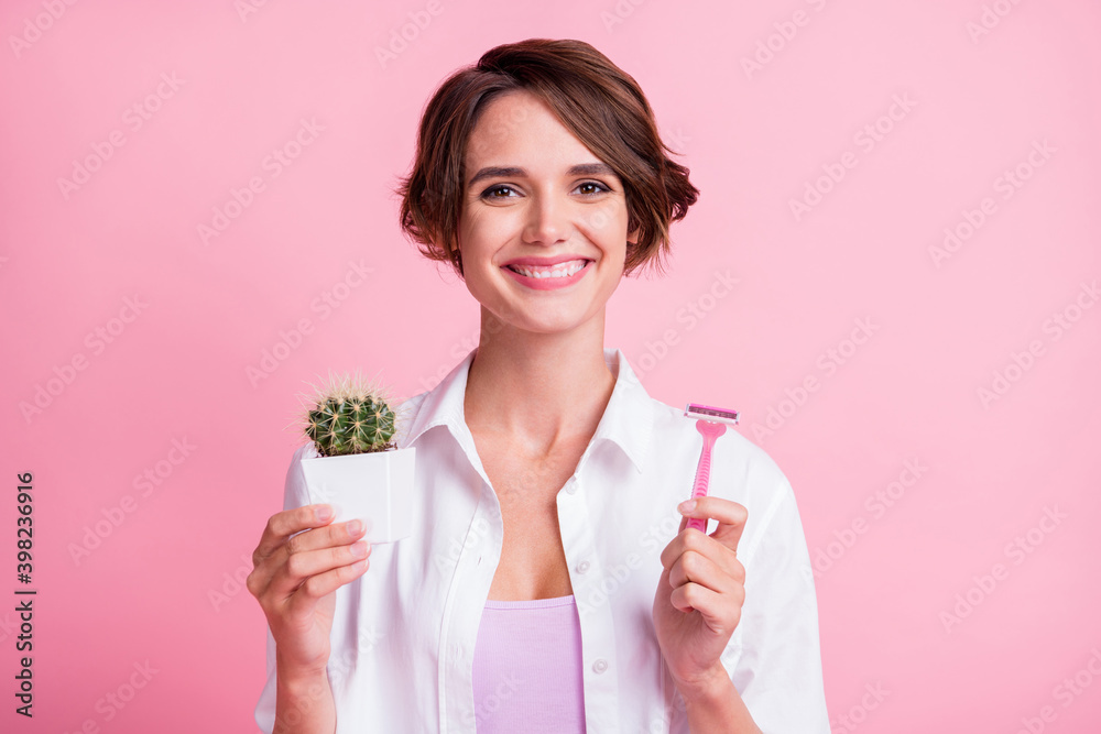Portrait of positive person hands hold razor cactus flower toothy smile isolated on pink color background Portrait of positive person hands hold razor cactus flower toothy smile isolated on pink color background