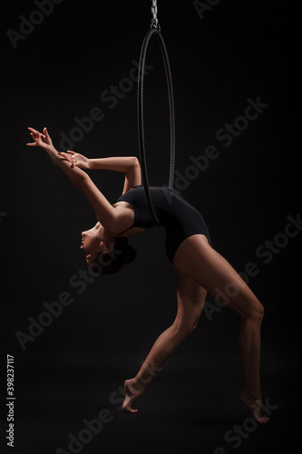 A female gymnast on an air ring (hoop)