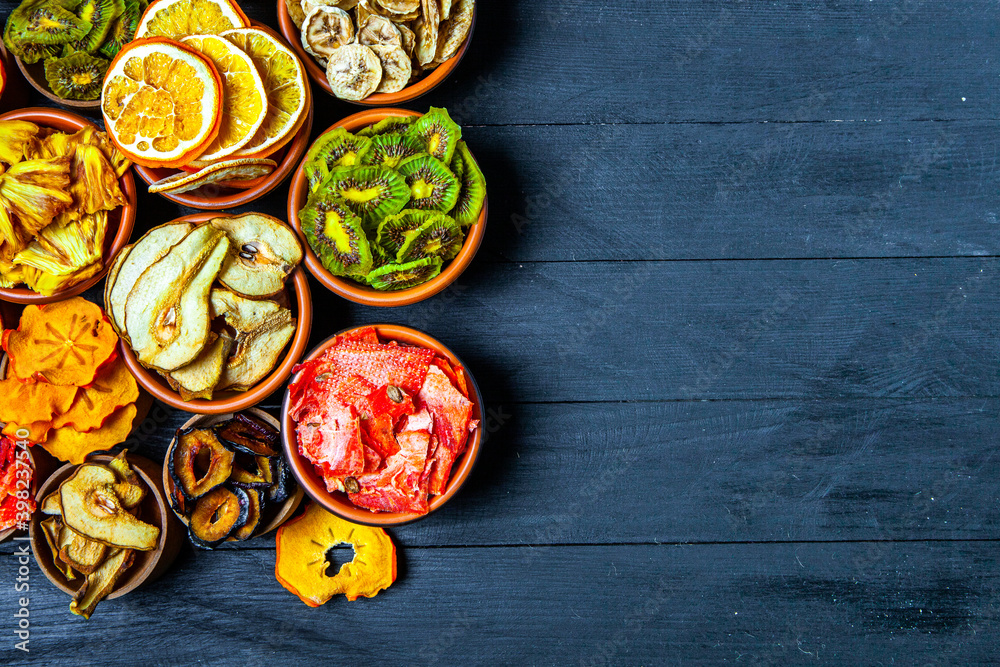 Organic Healthy Assorted Dried Fruit Mix close up. Dried fruit snacks. dried apples, mango, feijoa, dried apricots, prunes top view Organic Healthy Assorted Dried Fruit Mix close up. Dried fruit snacks. dried apples, mango, feijoa, dried apricots, prunes top view