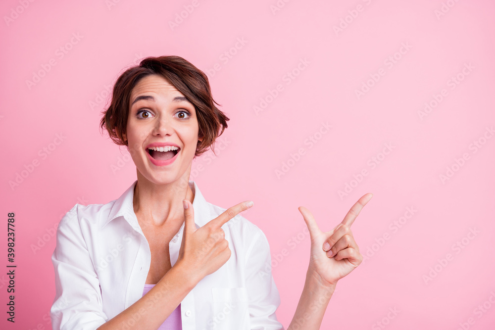 Photo of lovely amazed girl wear white shirt point empty space follow isolated on pastel pink color background Photo of lovely amazed girl wear white shirt point empty space follow isolated on pastel pink color background