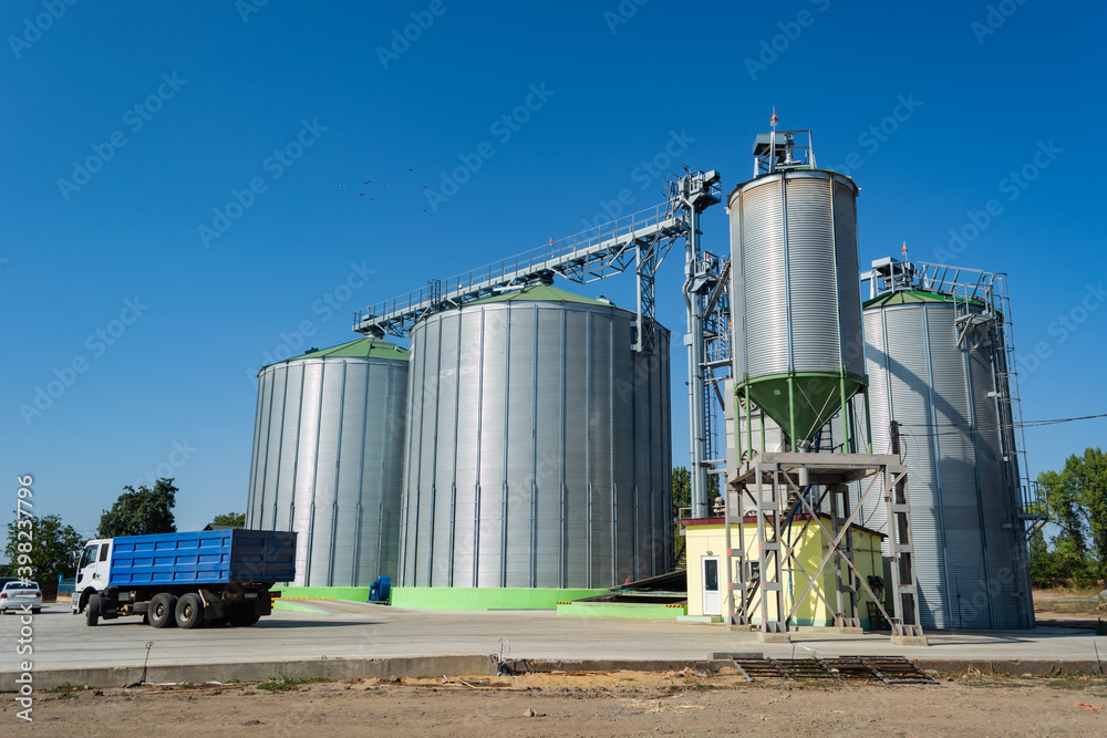 loading grain by trucks onto the elevator into metal containers