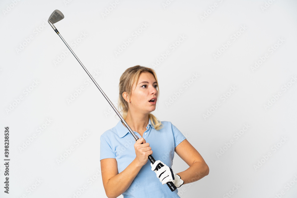 Young Russian woman isolated on white background playing golf Young Russian woman isolated on white background playing golf
