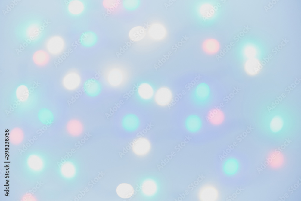 Background image close-up out of focus lights of a Christmas tree on a blue background. Bokeh. Background image close-up out of focus lights of a Christmas tree on a blue background. Bokeh.
