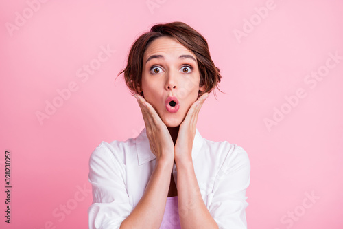 Photo portrait of shocked impressed girl touching cheekbones staring opened mouth isolated on pink pastel color background
