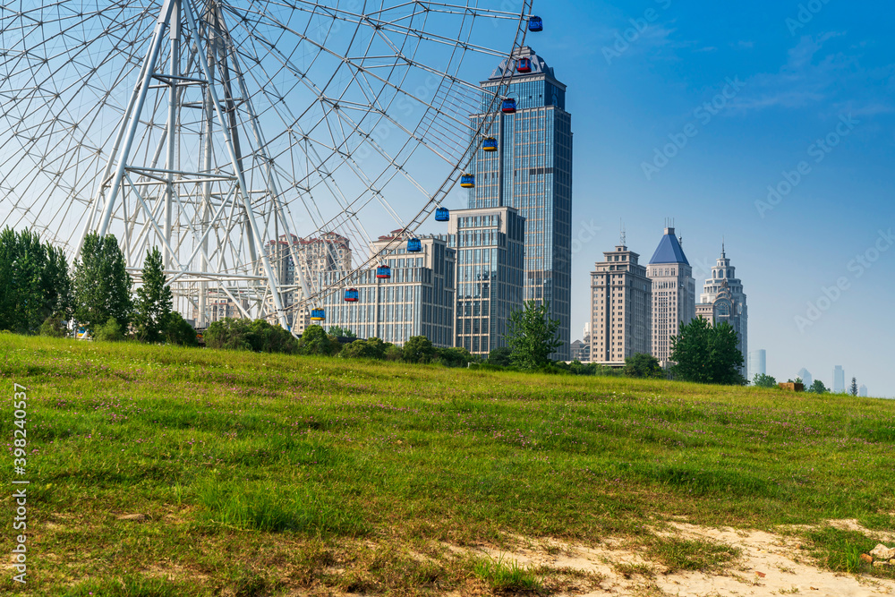 An empty road under the ferris wheel in a city park