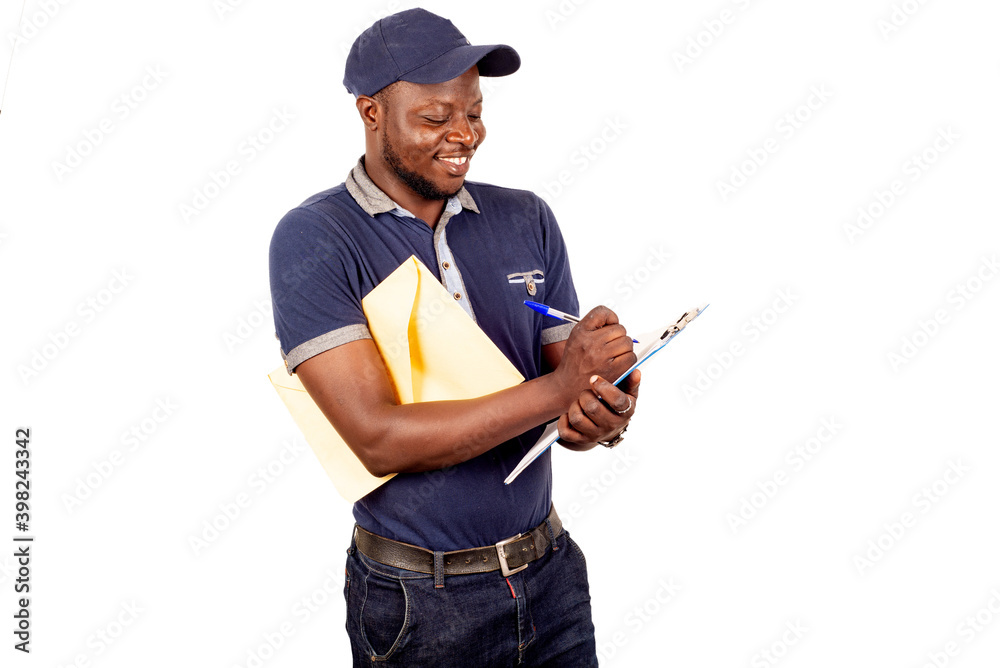young delivery man before his order list, smiling. young delivery man before his order list, smiling.