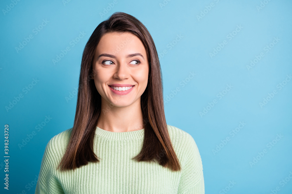 Photo of charming young girl white smile look side empty space wear green pullover isolated blue color background Photo of charming young girl white smile look side empty space wear green pullover isolated blue color background