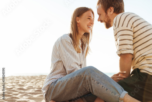 Loving couple sitting outside at the beach