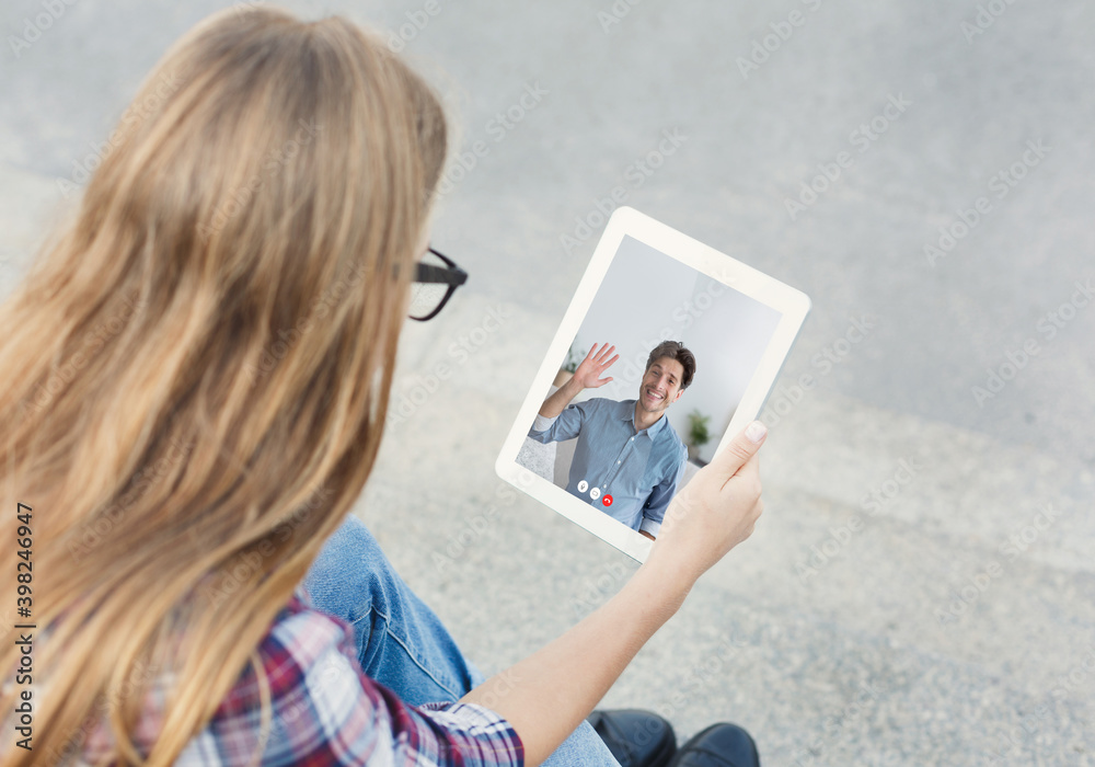 Girl Talking With Father Via Video Call On Tablet Outdoors