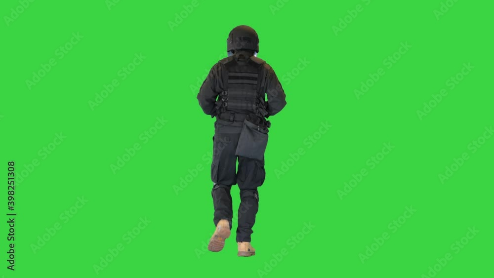 Swat SWAT man in uniform running on a Green Screen, Chroma Key. Swat SWAT man in uniform running on a Green Screen, Chroma Key.
