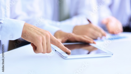 business man with a digital tablet analyzing a financial chart.