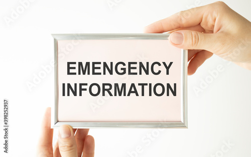 emergency information, text on white paper in hands.