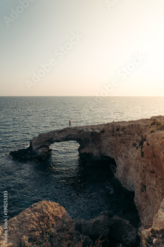 Cliff in Cyprus on the sunset women standing on the edge