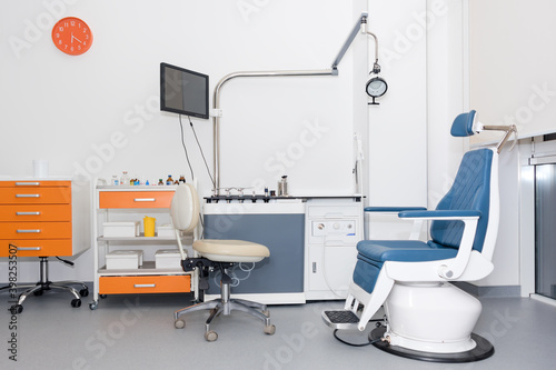 Modern dental practice. Dental chair and other accessories used by dentists. Dentist Office  Dental Hygiene. Colorful interior of dentistry office with chair and tools.