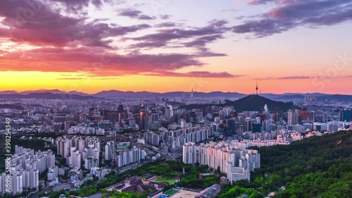 Zoom in, Time lapse 4K Sunrise of Seoul city skyline and Seoul tower modern building and architecture, Beautiful clouds flow through in Seoul, South Korea. photo