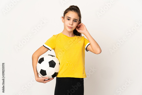 Little football player girl isolated on white background having doubts © luismolinero