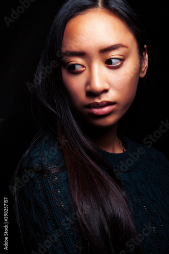 pretty young asian girl posing sensitive on black background  lifestyle people concept