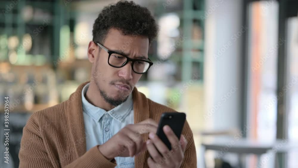 Young African Man using Smartphone, Browsing Internet Young African Man using Smartphone, Browsing Internet