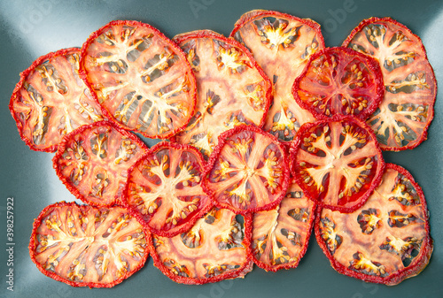 dried tomato slices on gray background. Vitamin vegetable food