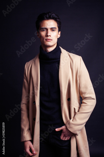 handsome asian fashion looking man posing in studio on black background, lifestyle modern people concept