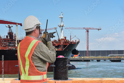 port controller, harbor master in command on the terminal port for safety and control security during the operation of ship in shipyard. photo