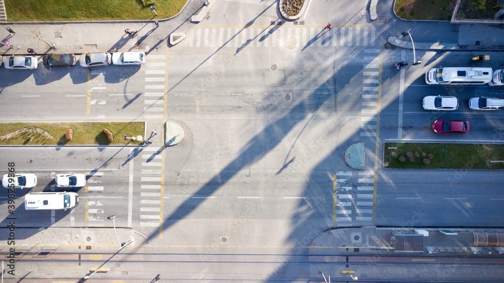 Naklejka premium Aerial view of the city traffics at the center. Vehicles are moving on the road between buildings.