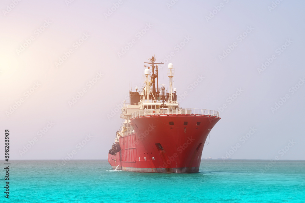 Tug boat sailing in the blue sea, front view of boat