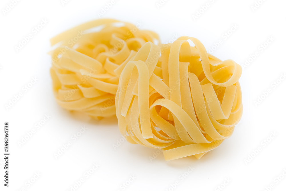 Italian pasta fettuccine nest isolated on white background Italian pasta fettuccine nest isolated on white background