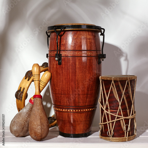 Composition of musical ethnic instrument. Maracas, tambourine, conga and ethnic drum. Percussion rhytm instruments photo