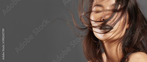 Fotografie Fashion Model with Long Blowing Hair