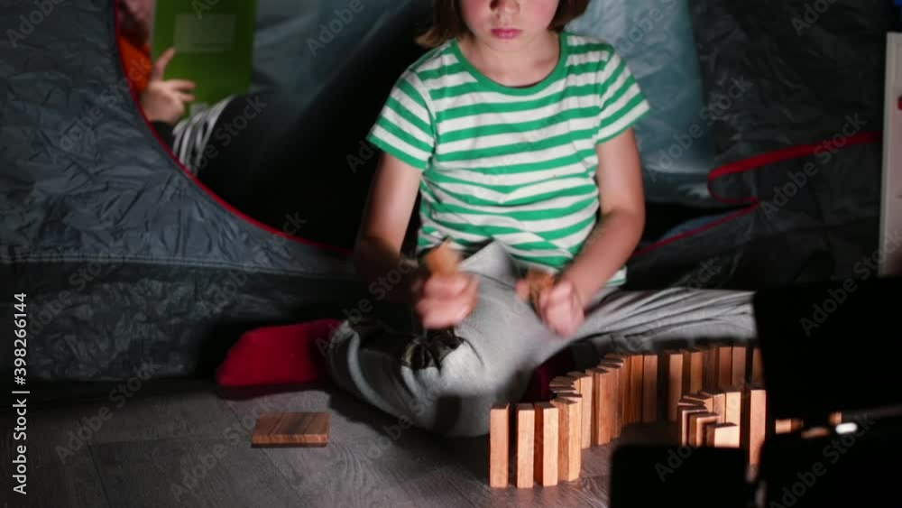 The boy puts the cubes in a row on the edge. A game that makes the child's mental balance. An independent game of self-isolation. The boy puts the cubes in a row on the edge. A game that makes the child's mental balance. An independent game of self-isolation.