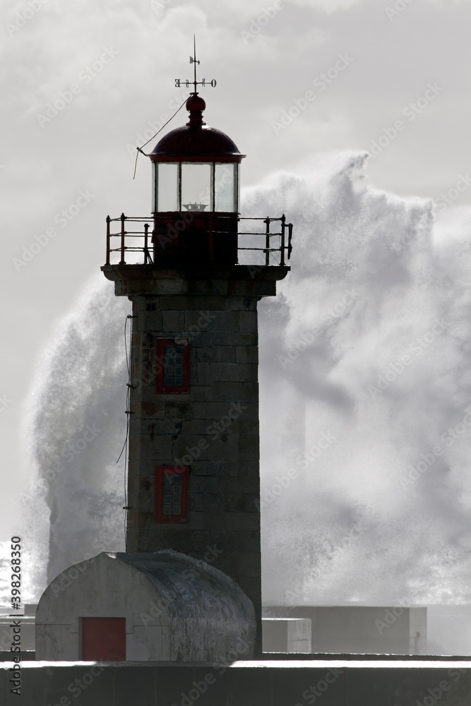 Backlit lighthouse during storm