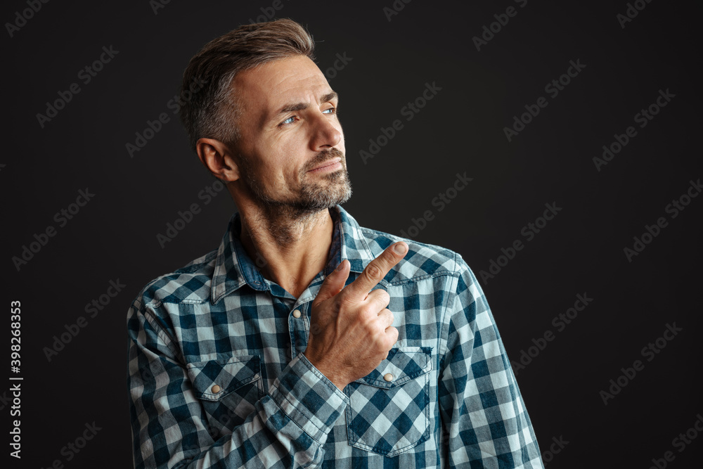 Serious grey-haired man pointing isolated Serious grey-haired man pointing isolated